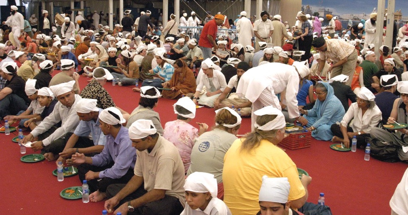 Volunteers serving free community langar meal